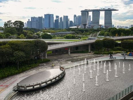How does Singapore punch above its weight when it comes to attracting FDI?