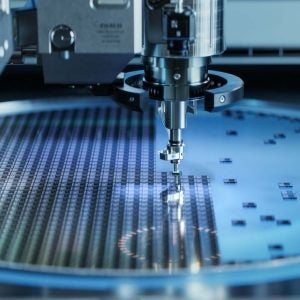 Computer Chip Manufacturing. Semiconductor Wafer after Dicing Process. Silicon Dies are Being Extracted by Pick and Place Machine. Packaging Process.